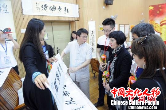 碧翠园学校老师向乌鲁蒂亚女士介绍中国书法特点。　蒋雪林 摄